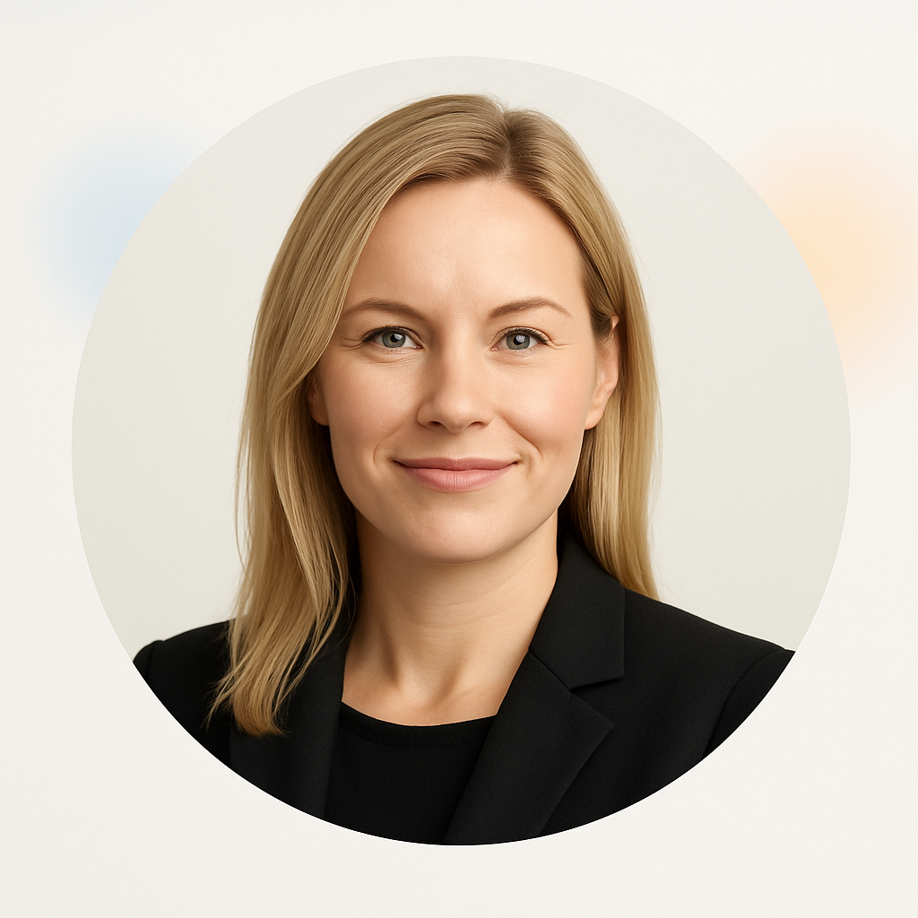 Portrait of Camilla Andersen, a woman with blonde hair in a black blazer, smiling confidently