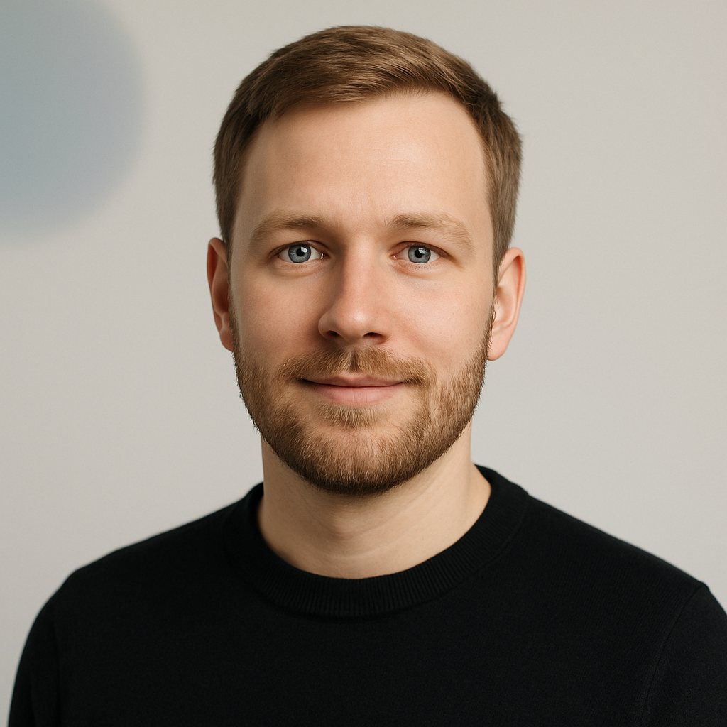 Portrait of Jonas Brodersen, a man with light brown hair and short beard, black sweater