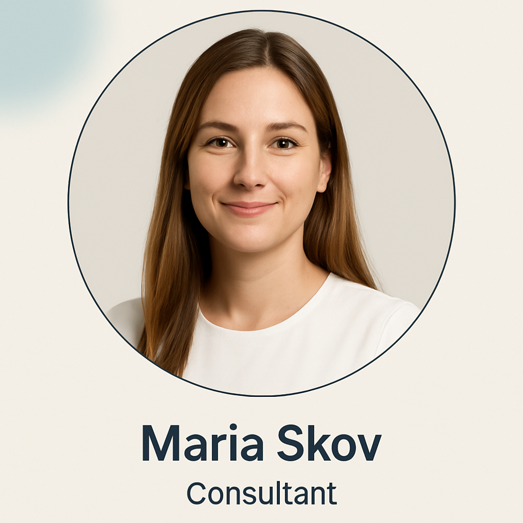 Portrait of Maria Skov, a woman with long dark blonde hair, white top, friendly expression