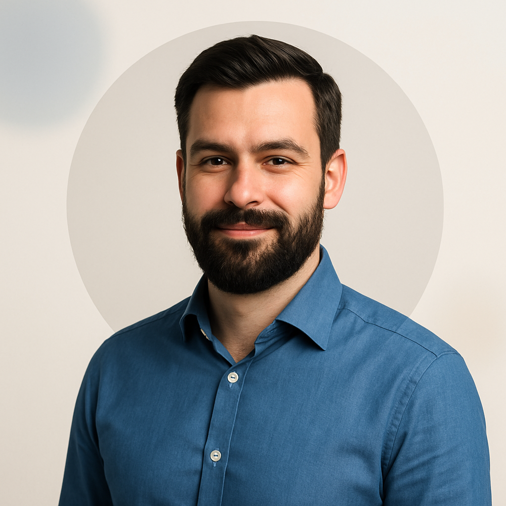 Portrait of Martin Nielsen, a man with dark beard, blue shirt, and confident smile
