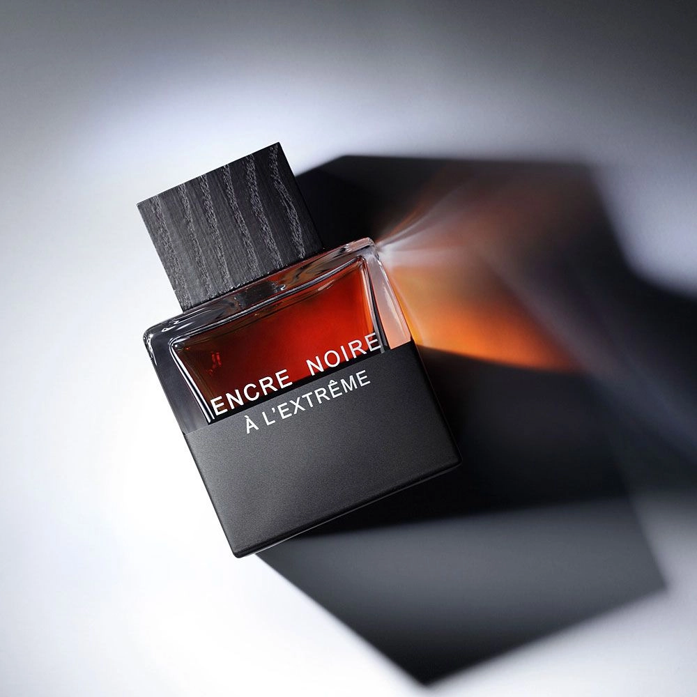 Lalique Encre Noire A L'Extreme fragrance bottle on a dark, moody background