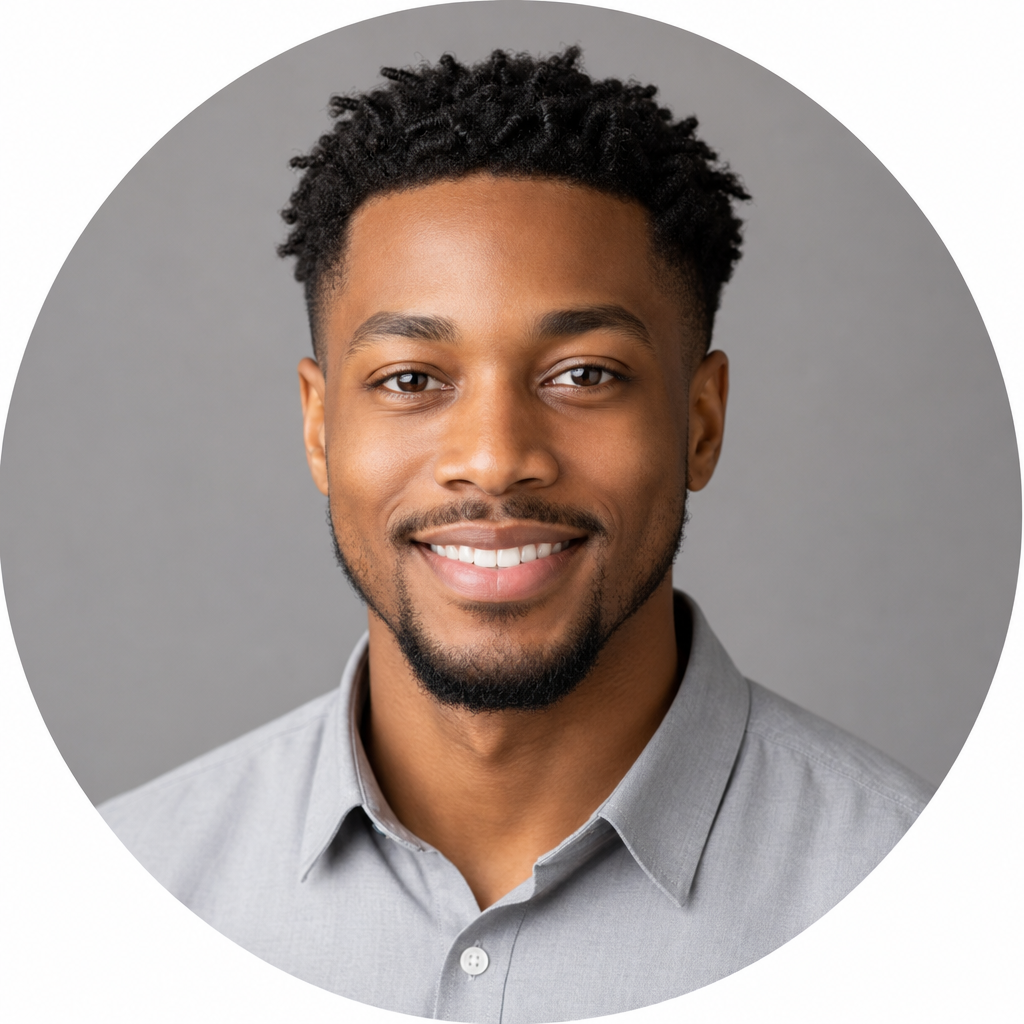 Professional headshot of a young African American man with short twists wearing a light gray button-down shirt