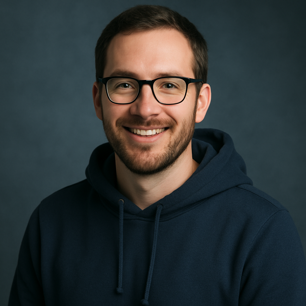 Portrait of a smiling man with glasses wearing a navy hoodie