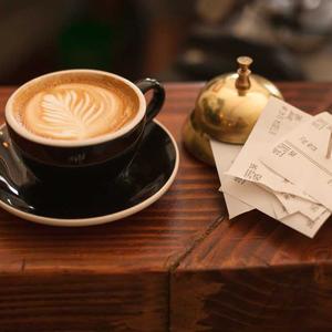 Cup of coffee on a wooden cafe table