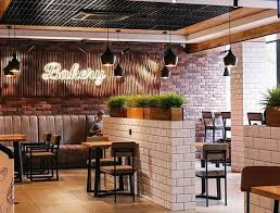 Bakery dining area with warm lighting, tiled counters, and seating