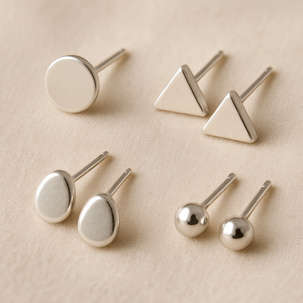 Tiny polished silver stud earrings with minimalist design, versatile everyday jewelry