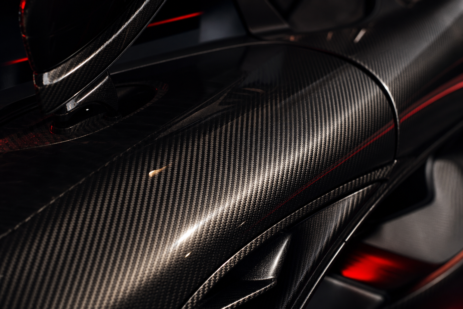 Macro closeup of exposed carbon monocoque weave on VELOCITY R9 body panel