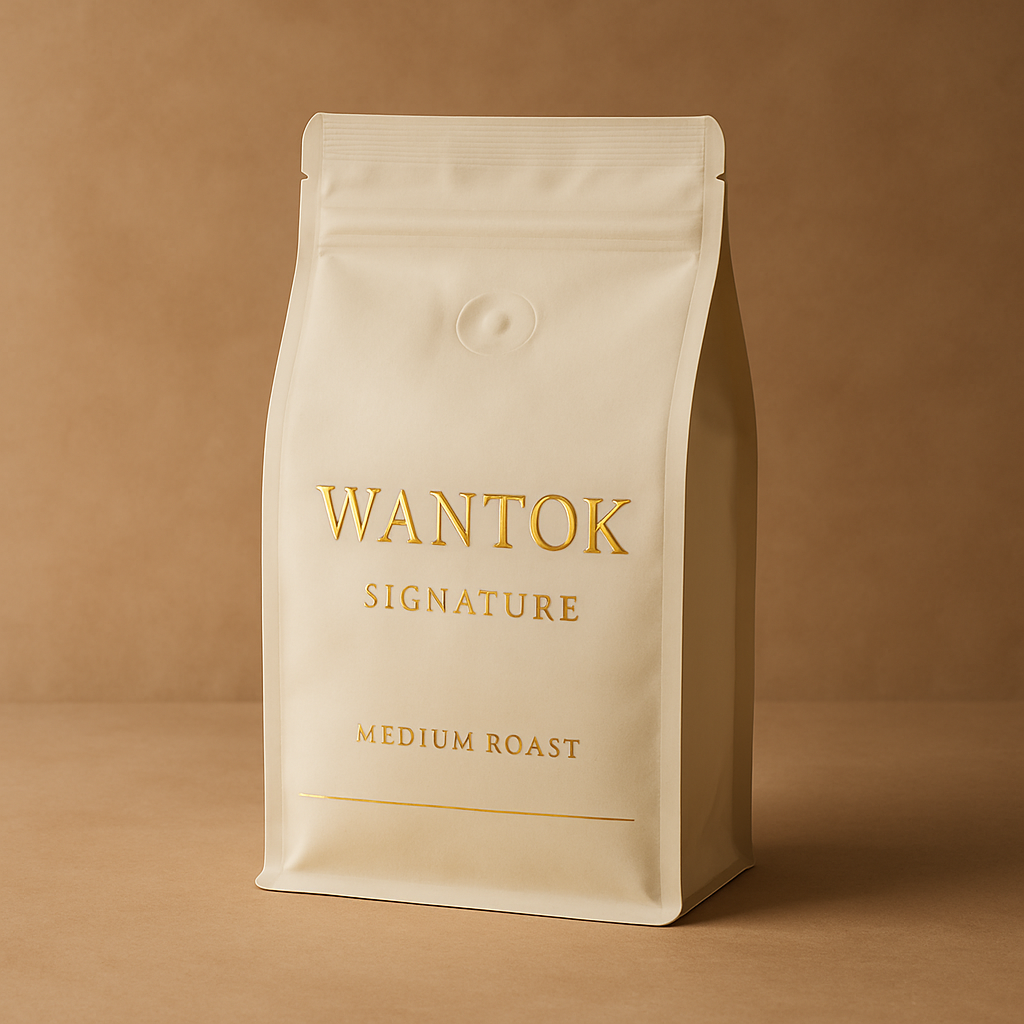 Cream-colored coffee bag with gold embossing labeled Wantok Signature Medium Roast