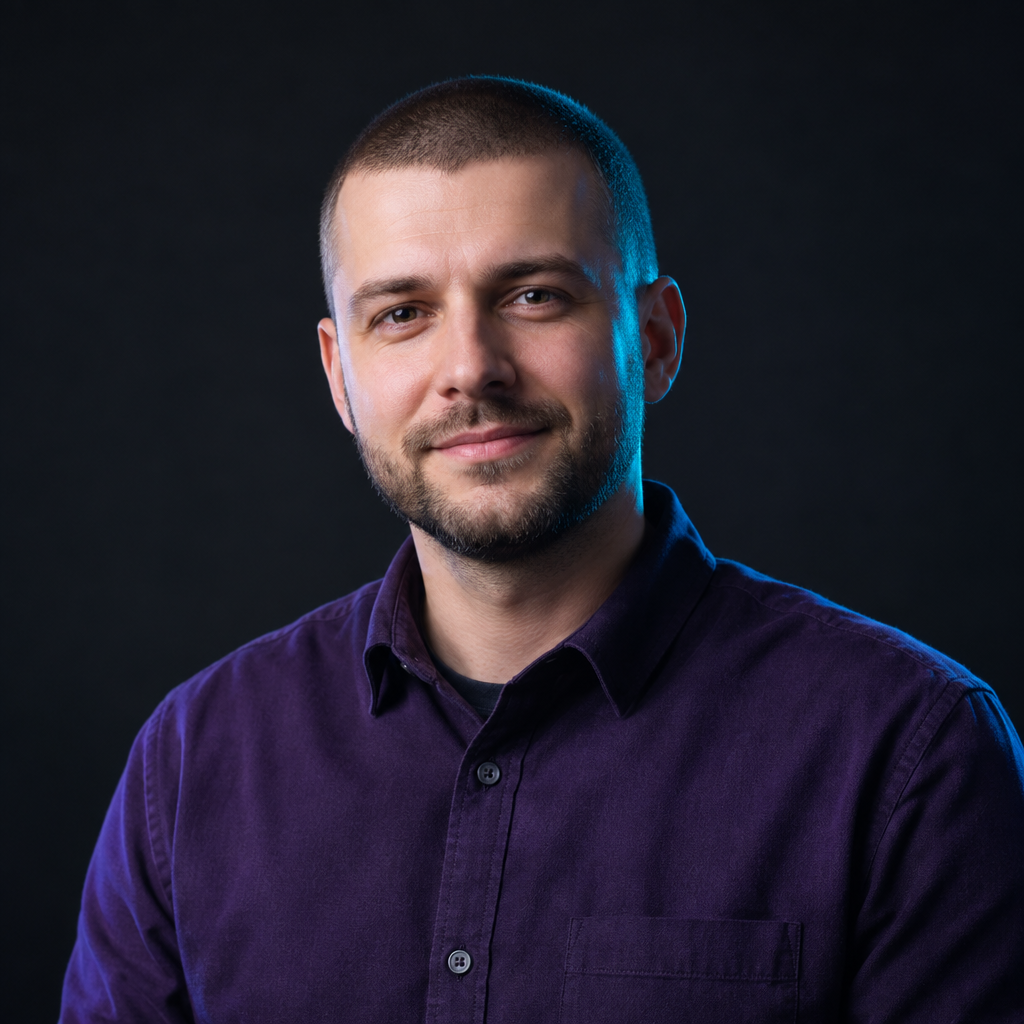 Portrait of Denys Koval, a Ukrainian accessibility specialist with close-cropped hair and a deep violet shirt