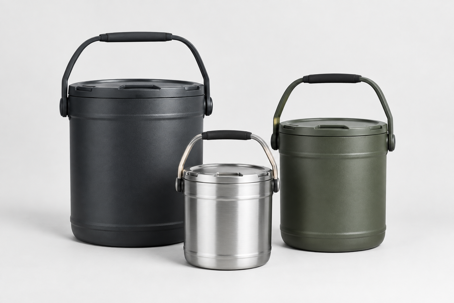 Three outdoor carry buckets in different sizes arranged on a clean studio surface, with sturdy handles and matte utility finishes