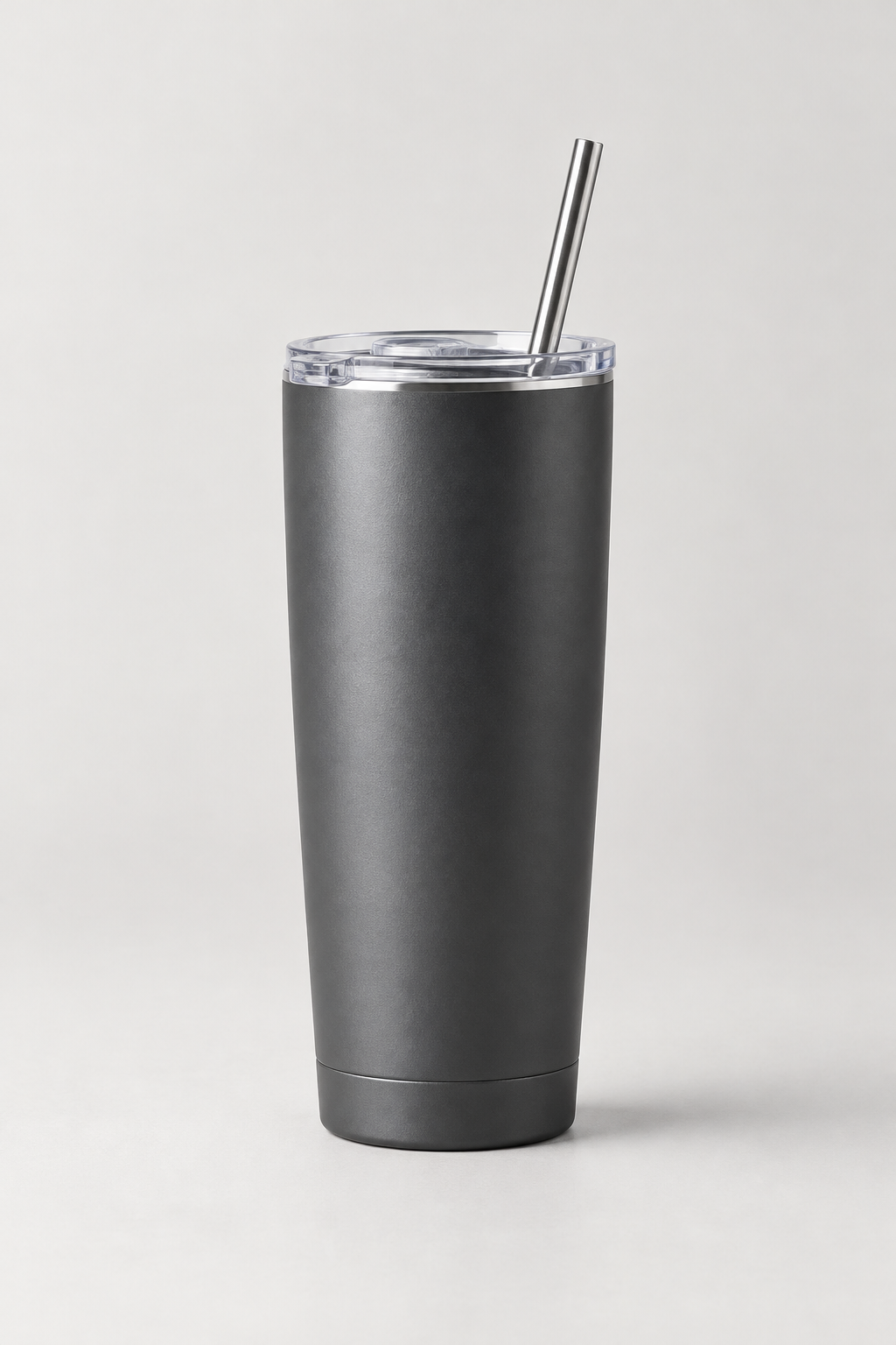 Matte stainless steel tall tumbler with lid and metal straw, studio-lit on a clean neutral surface