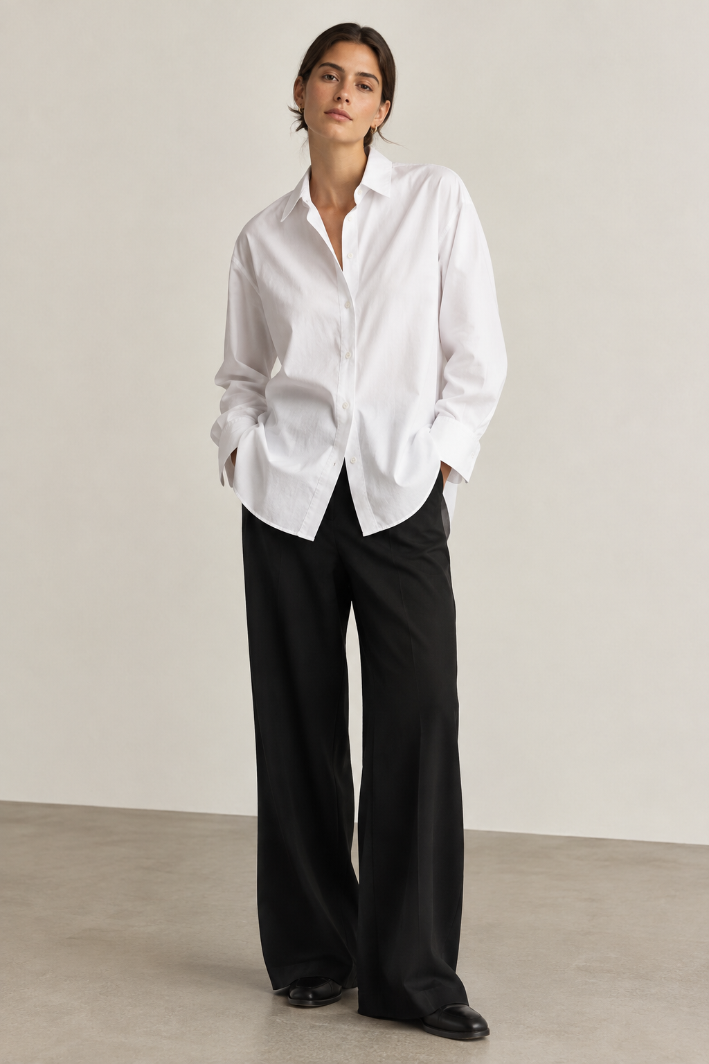 Oversized white button-down shirt styled with clean modern lines