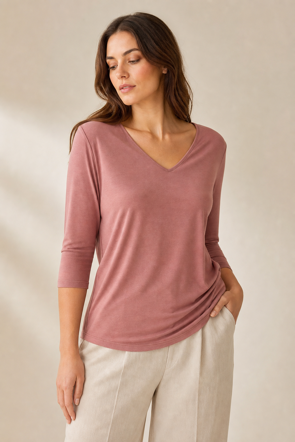 Relaxed v-neck jersey top in muted rose color on studio background