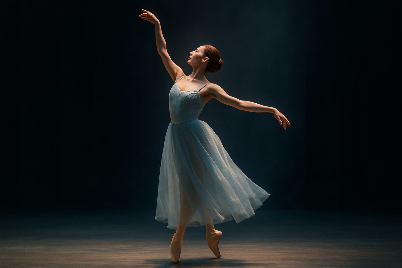 A solo ballerina in a flowing pale blue costume illuminated by soft stage lighting during a performance