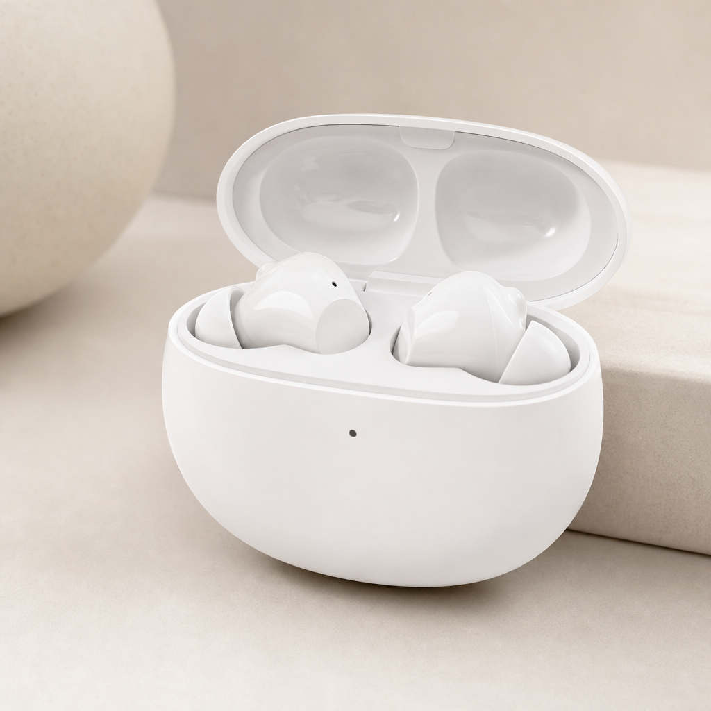 White wireless earbuds in an open charging case photographed in soft studio light