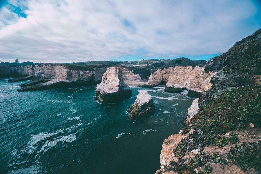 Rocky coastal cliffs and sea stacks above turquoise water