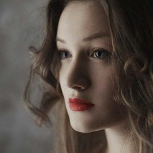 Close-up portrait of a woman with dark hair and red lipstick