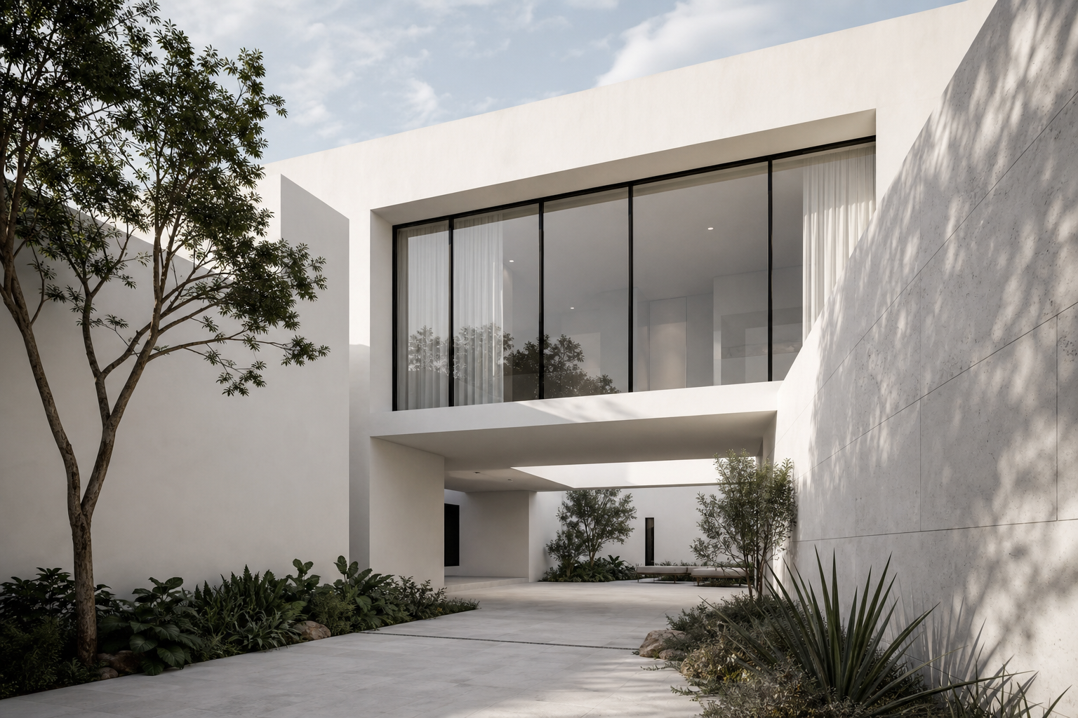 Minimalist contemporary residence with clean white concrete volumes, deep shadow lines, and warm daylight filtering through tall glazing, photographed in Mexico