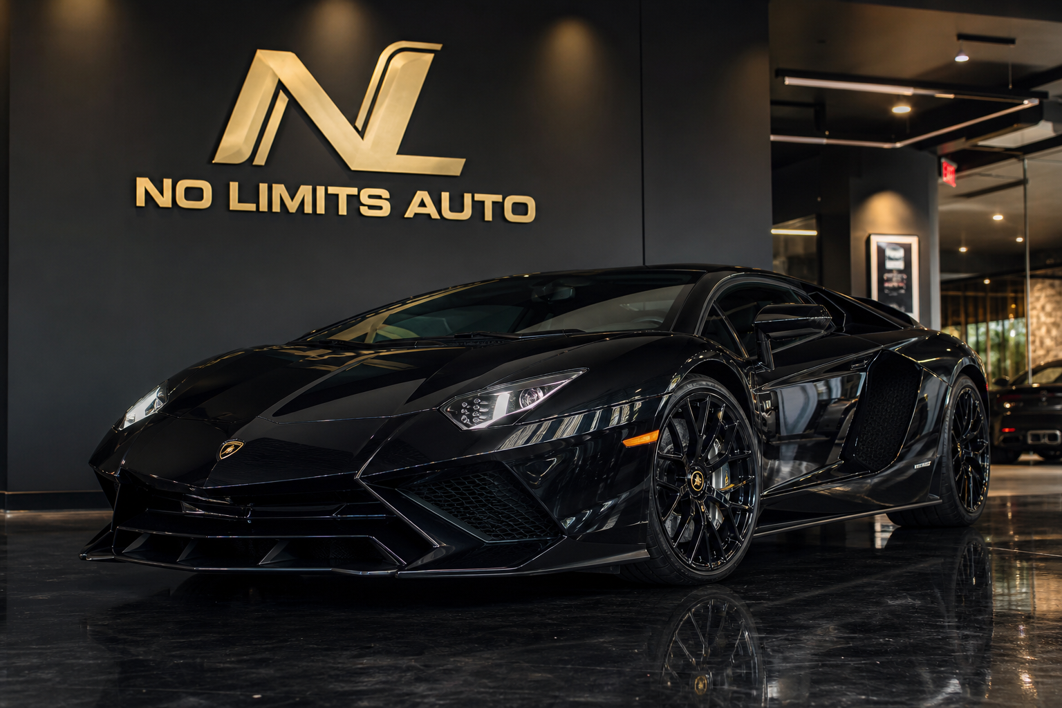 2021 Lamborghini Aventador in metallic Nero Helene black, photographed in a premium indoor showroom with a wall-mounted No Limits Auto logo matching the provided reference