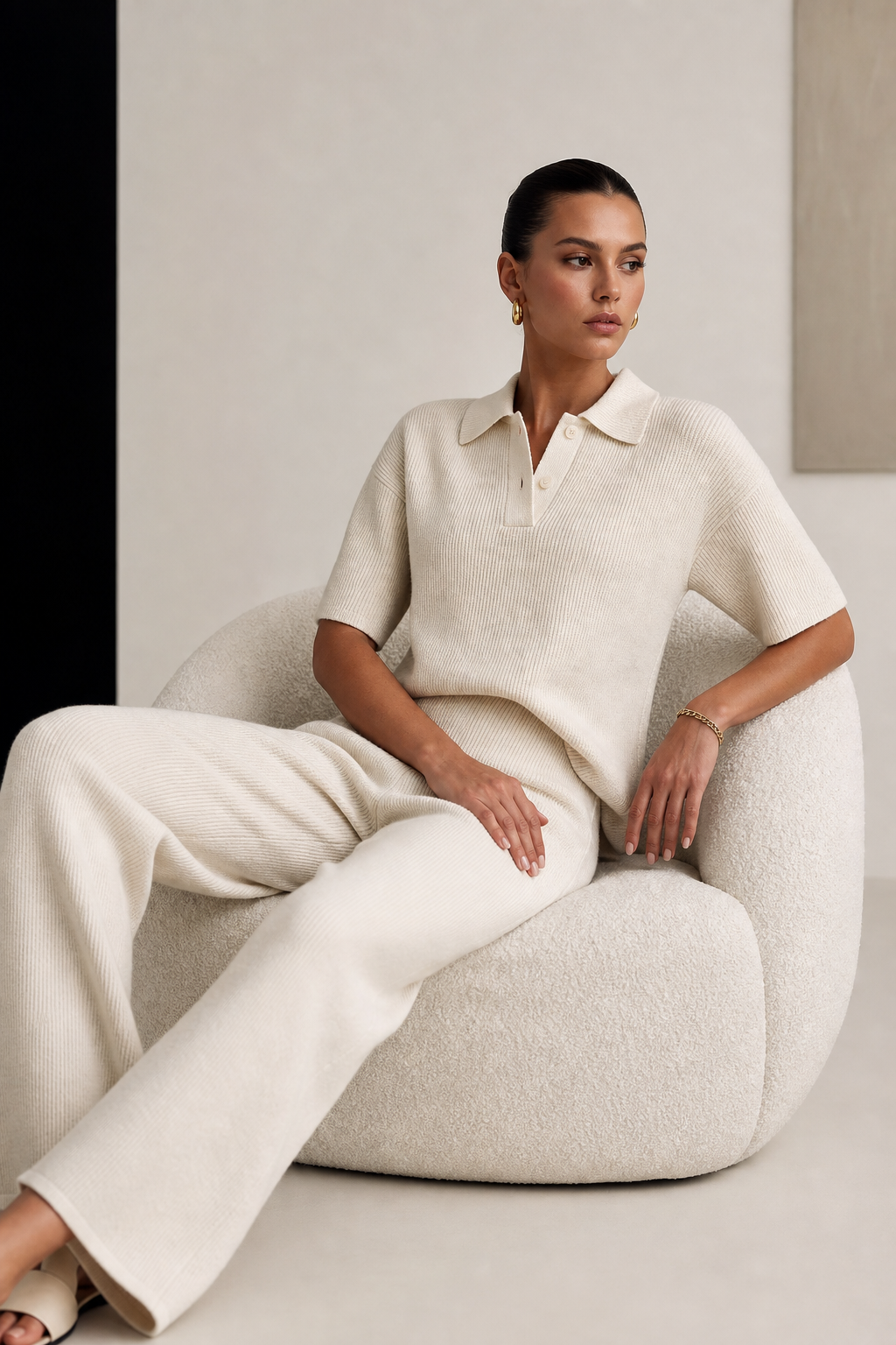 Model wearing a cream knit polo with matching wide-leg knit trousers