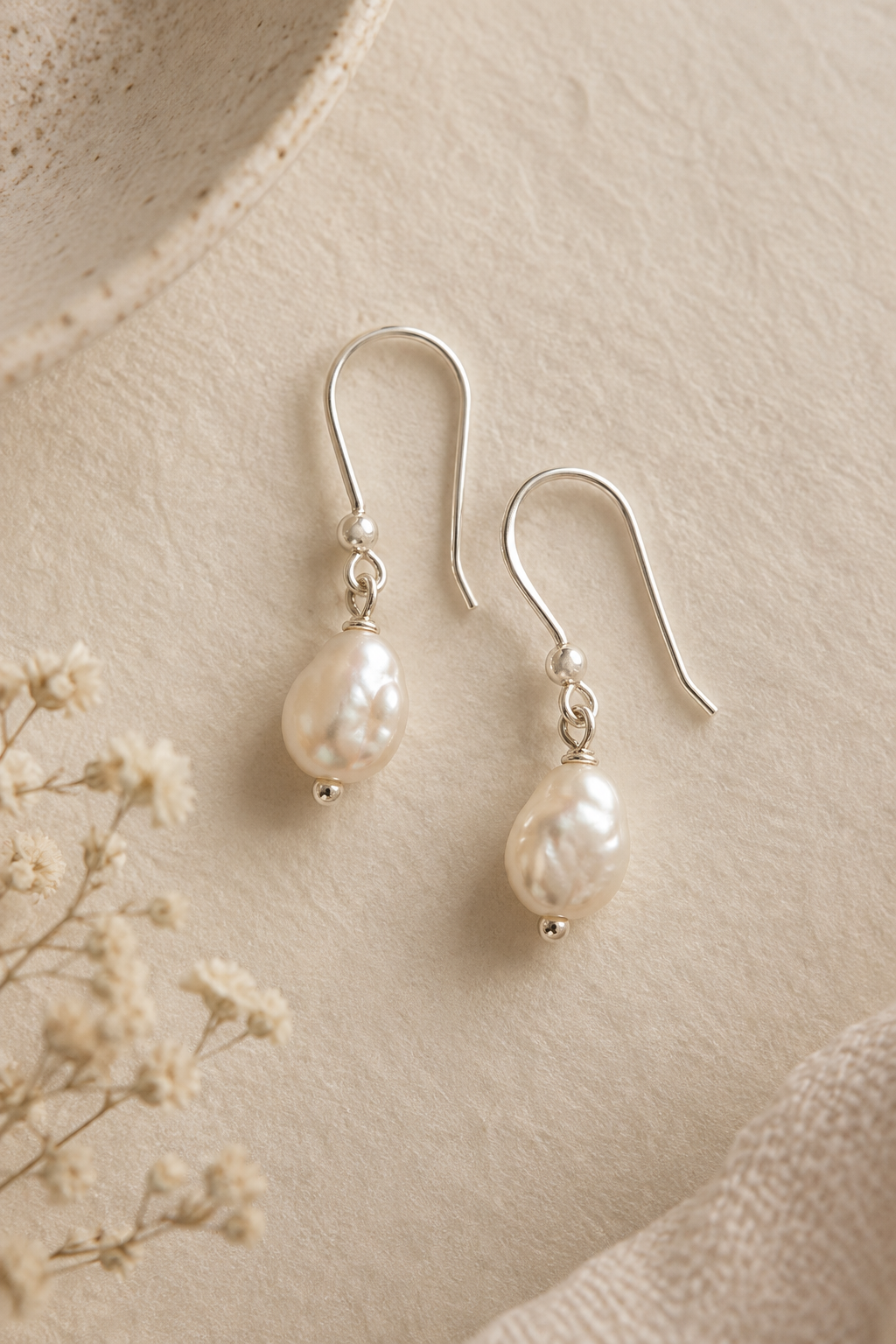 Handmade silver drop earrings with small irregular cream pearls