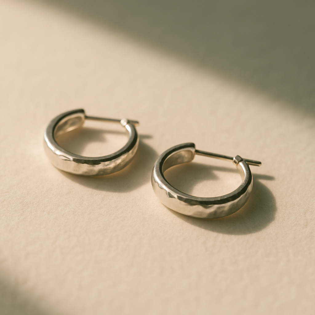 Pair of small silver hoop earrings with subtle hammered finish