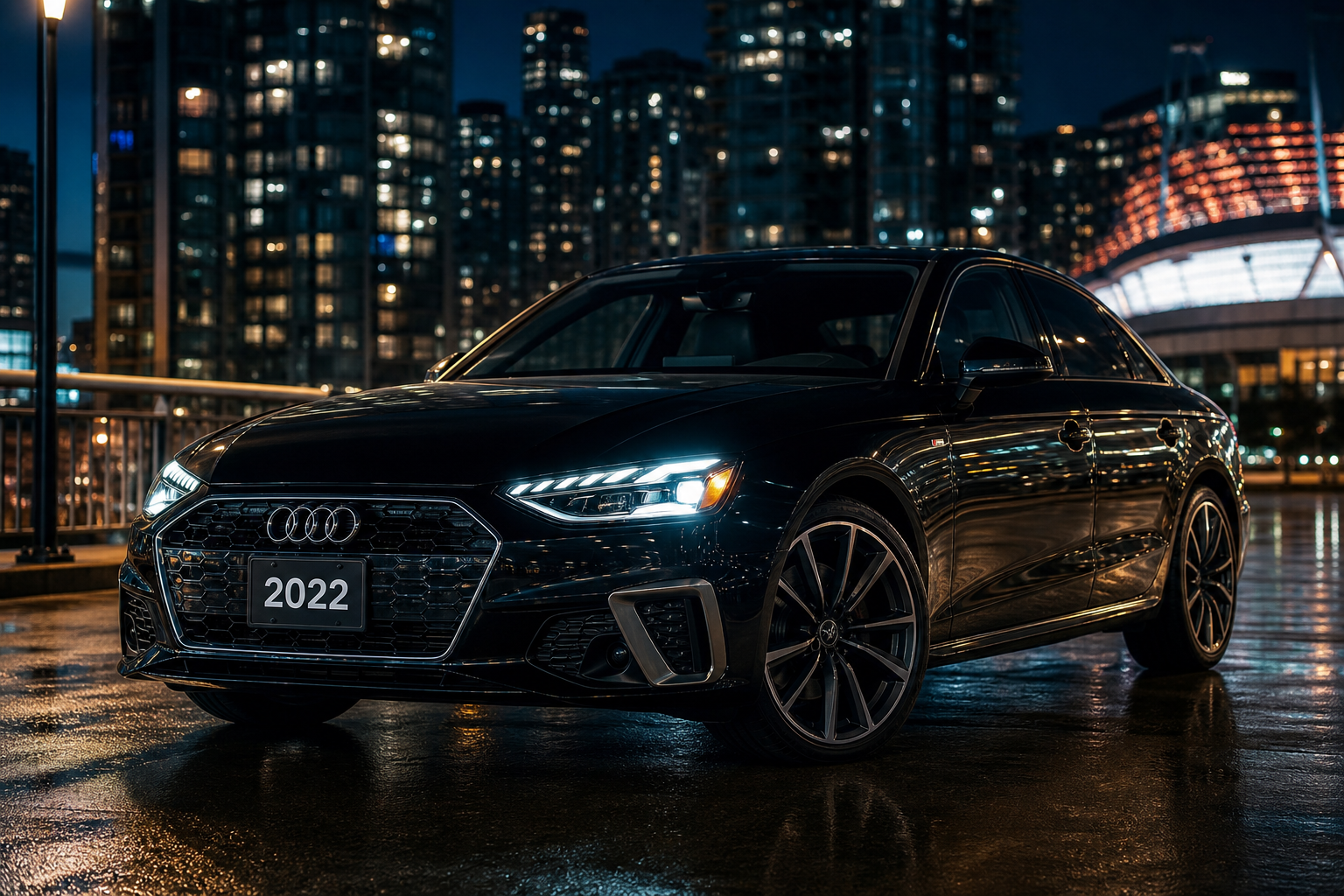 Black Audi A4 sedan parked under evening lights with clean reflections