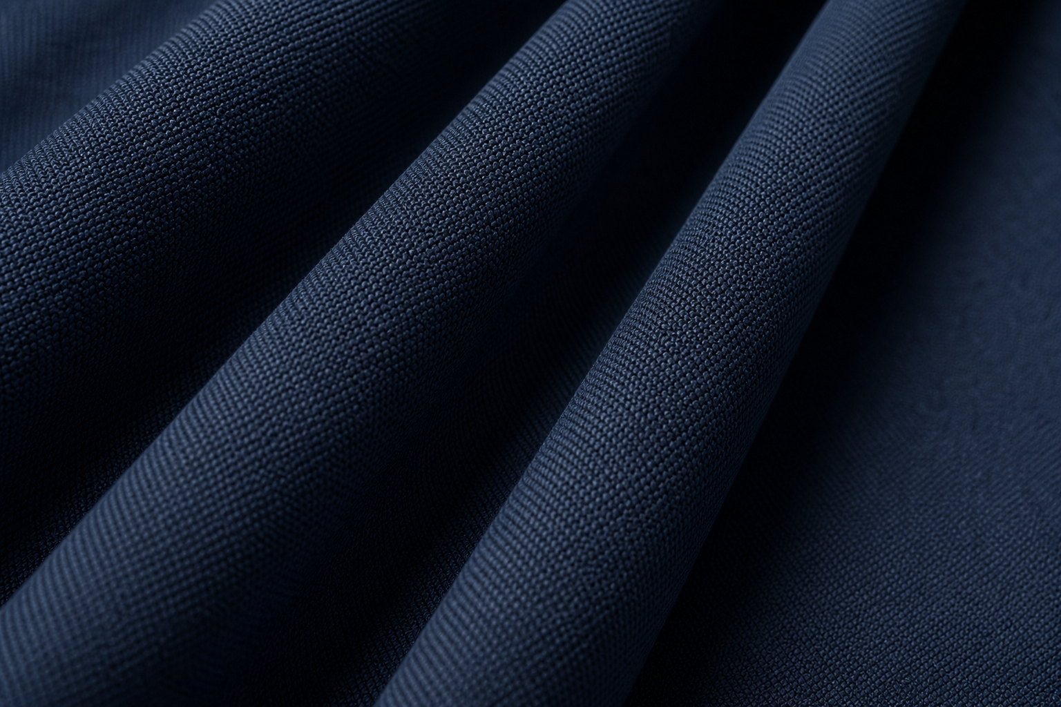 Detailed macro of deep navy textured acoustic drapery textile designed for reverberation control