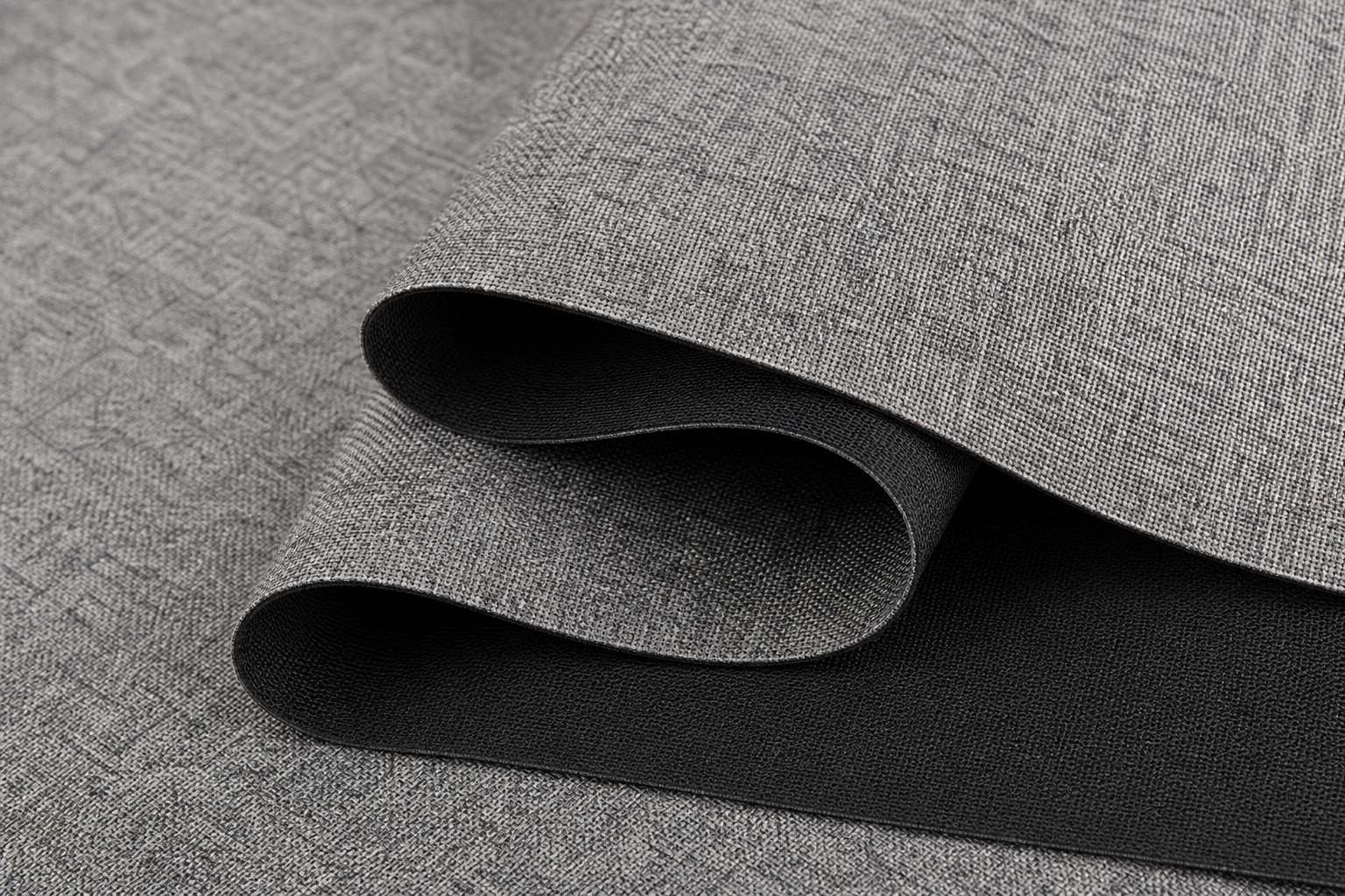 Macro view of stone gray melange blackout textile featuring dense black-yarn core construction