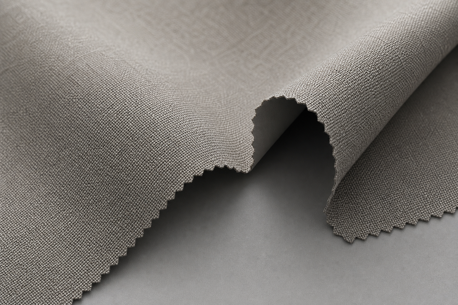 Close texture shot of warm gray coated blackout curtain fabric with smooth matte back coating