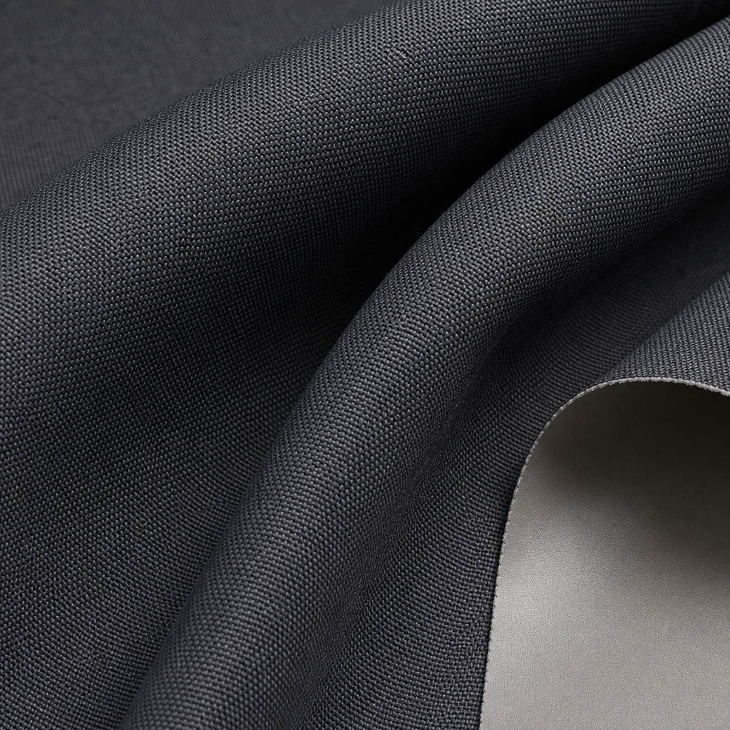 Close-up of premium blackout curtain fabric texture showing dense weave, smooth coated back, and refined drape surface