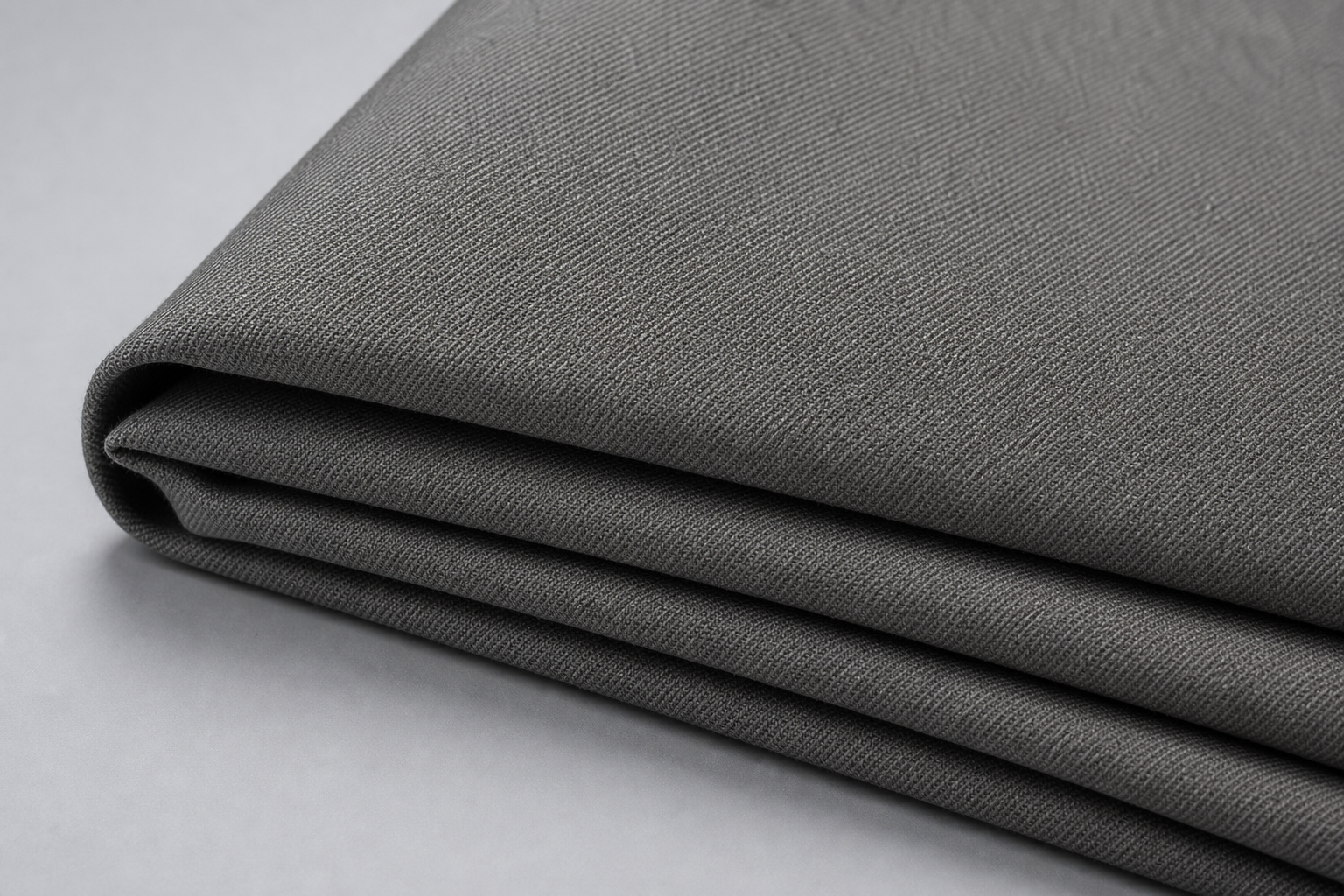Durable polyester FR blackout curtain fabric in warm gray with subtle twill texture for contract use