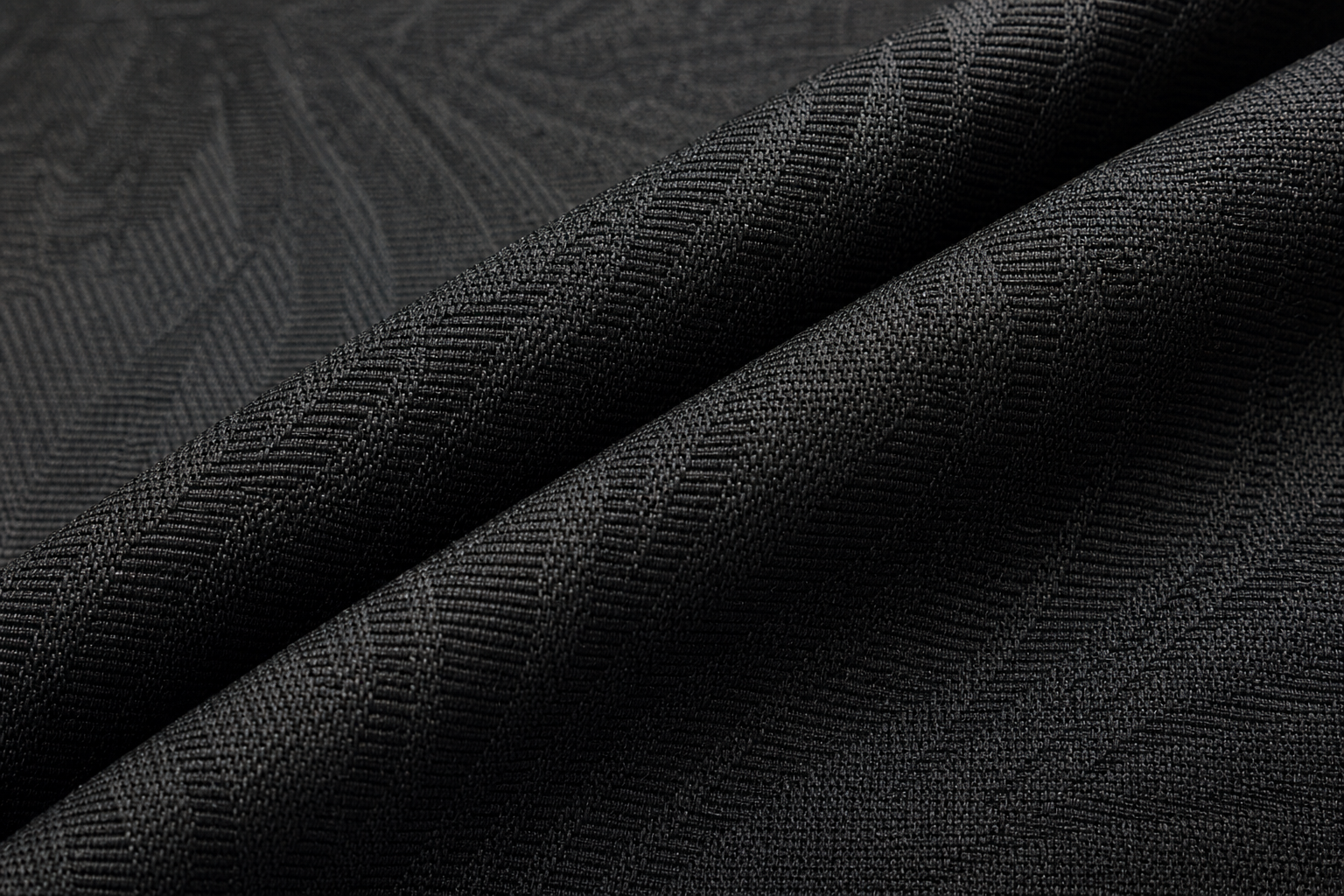 Detailed macro of dark charcoal jacquard post-treated flame retardant curtain textile