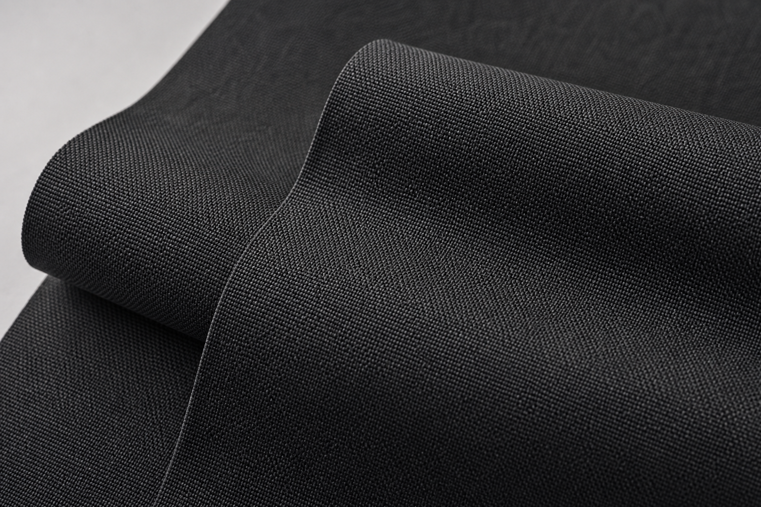 Close-up of tightly woven matte charcoal inherent flame retardant polyester curtain fabric