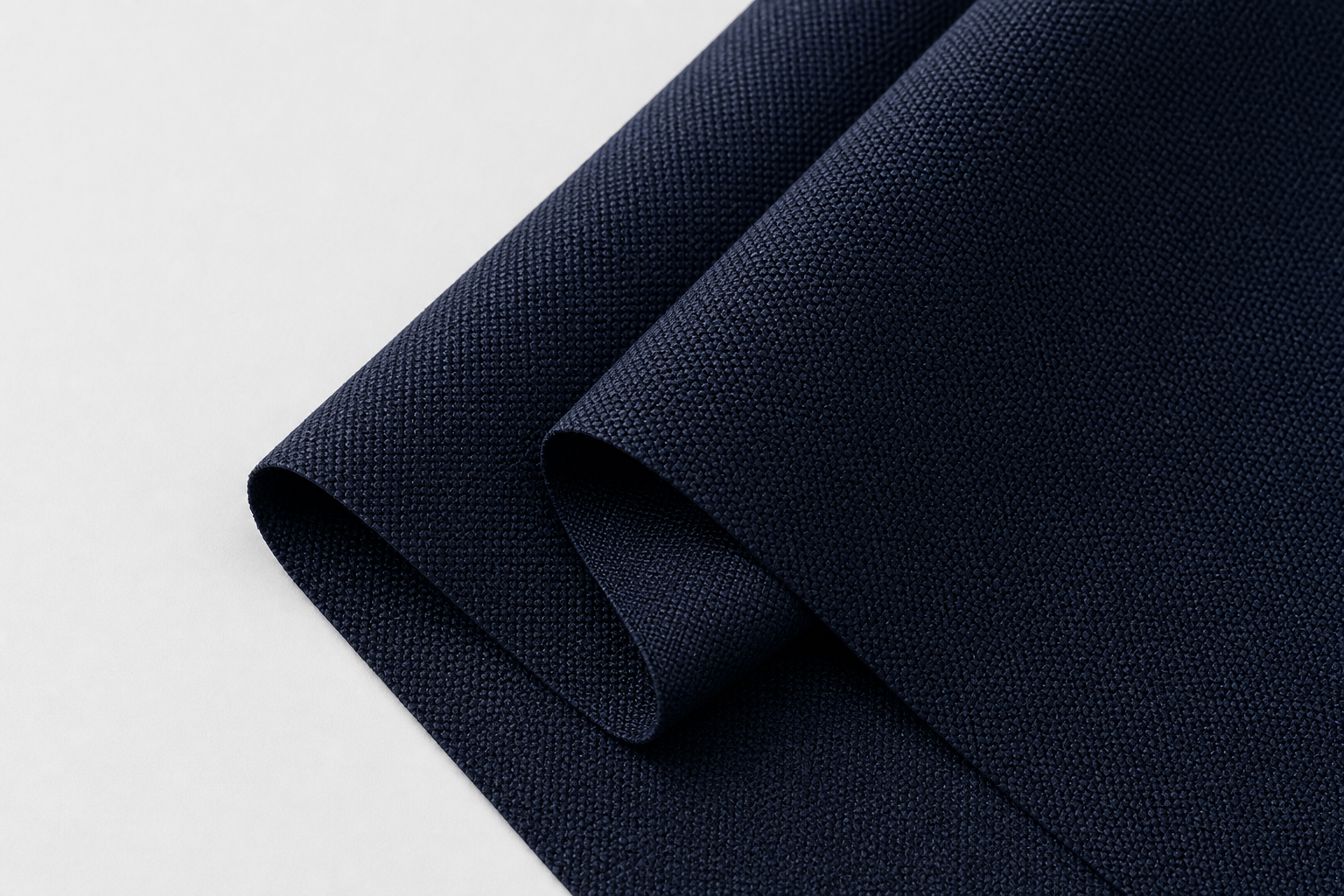 Close-up of tightly woven inherent flame retardant polyester curtain fabric in deep navy with fine matte texture