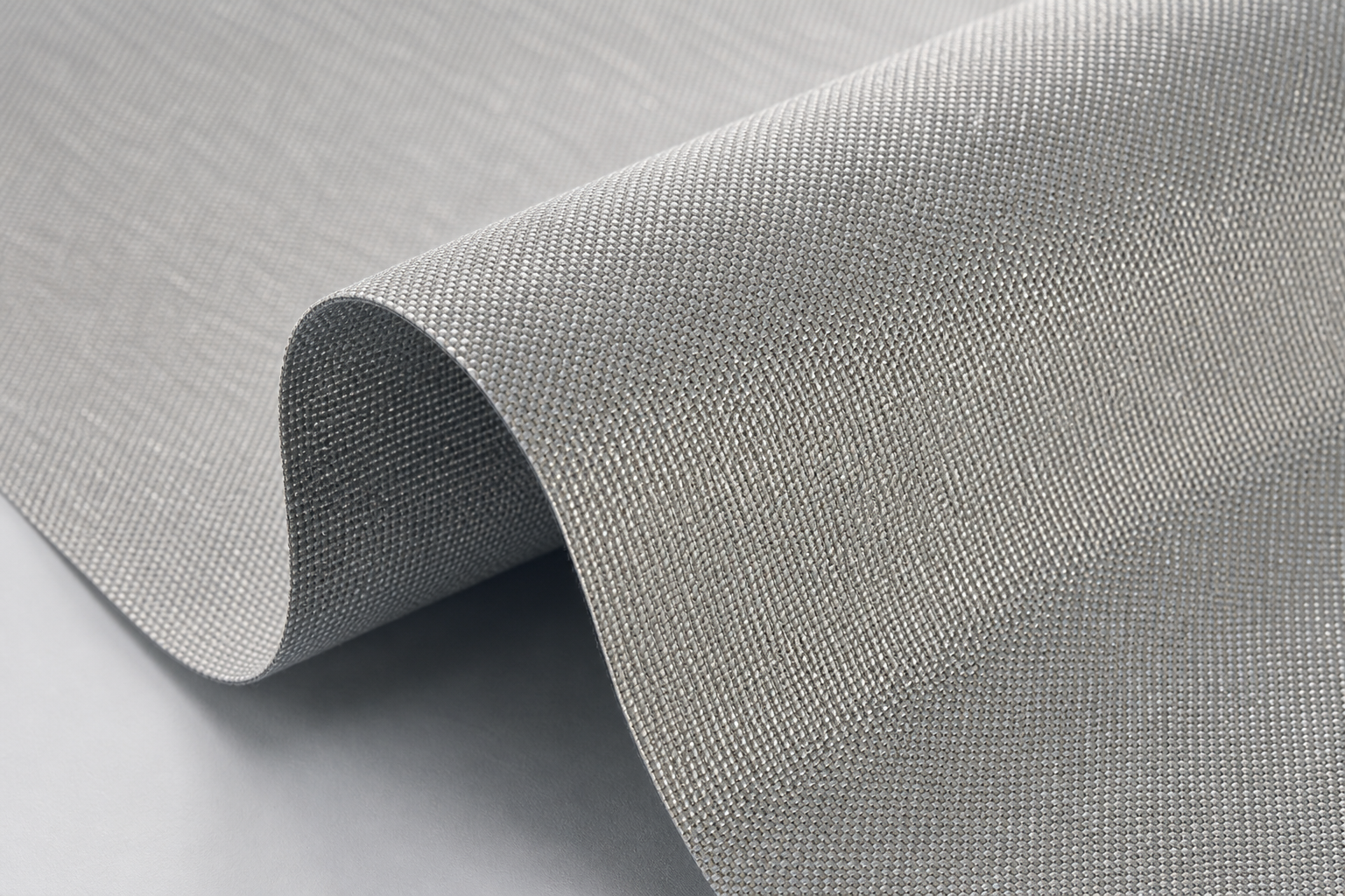 Close-up of light silver-gray solar-control curtain fabric with reflective yarn and fine technical weave