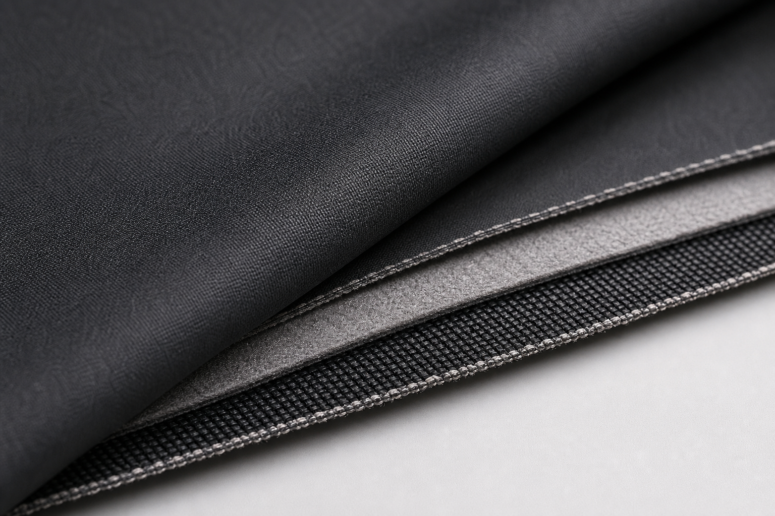 Detailed macro of deep graphite thermal-insulation curtain textile with multilayer core and matte face