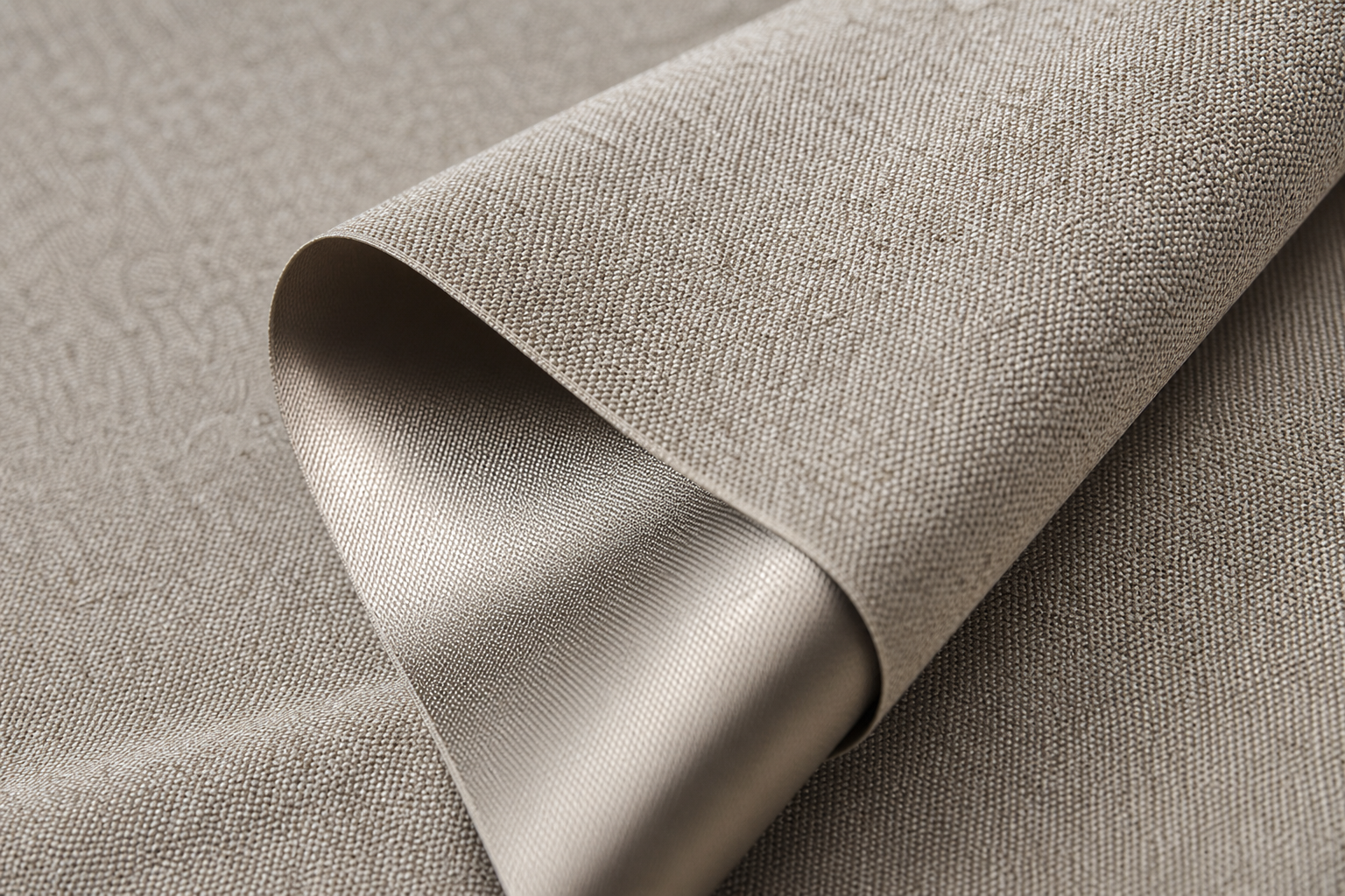 Macro view of warm stone-beige sun-shading fabric with textured face and high infrared reflection finish