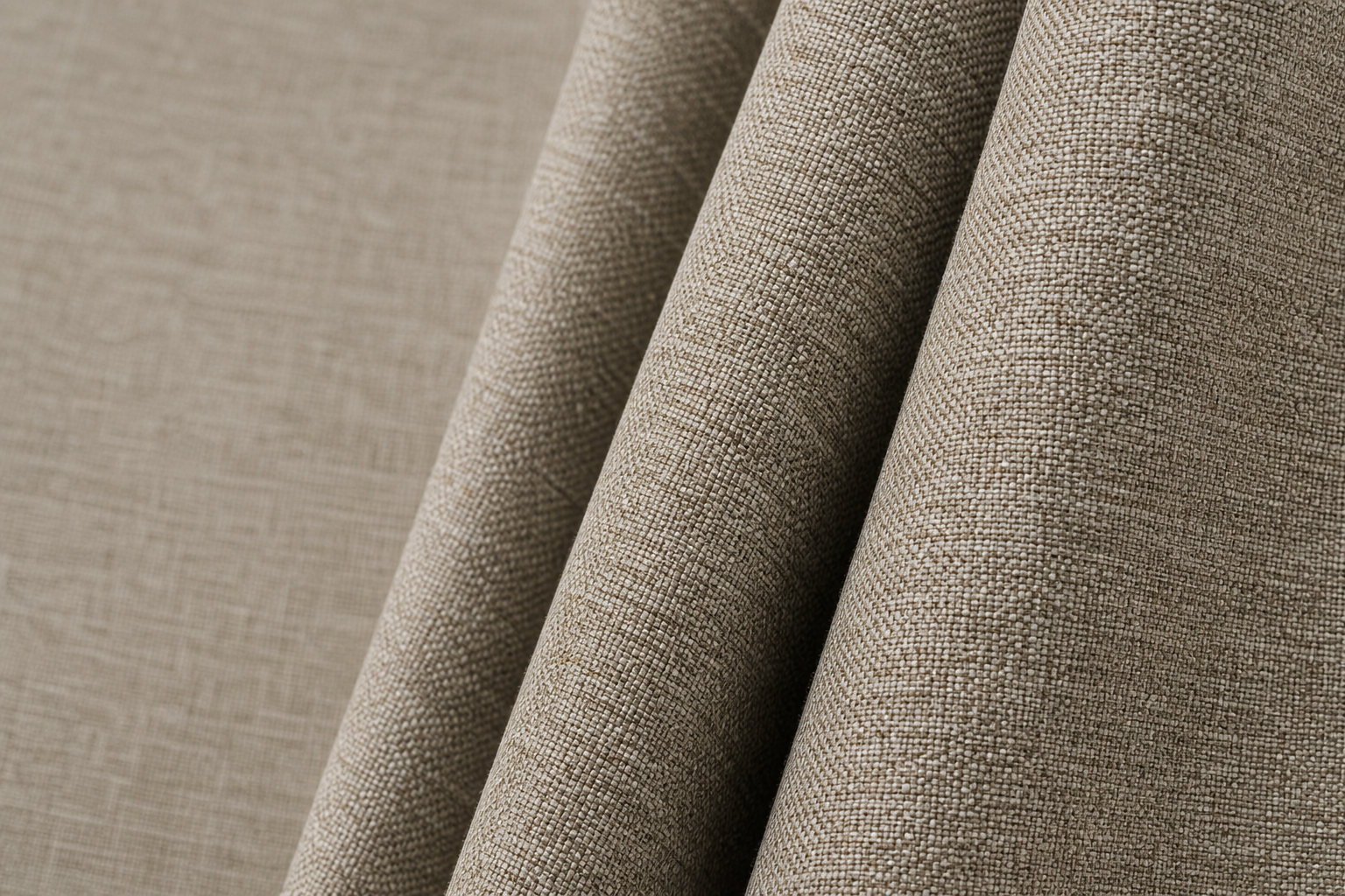 Macro view of warm stone-beige textured three-proof fabric engineered for contract drapery durability and low-maintenance care