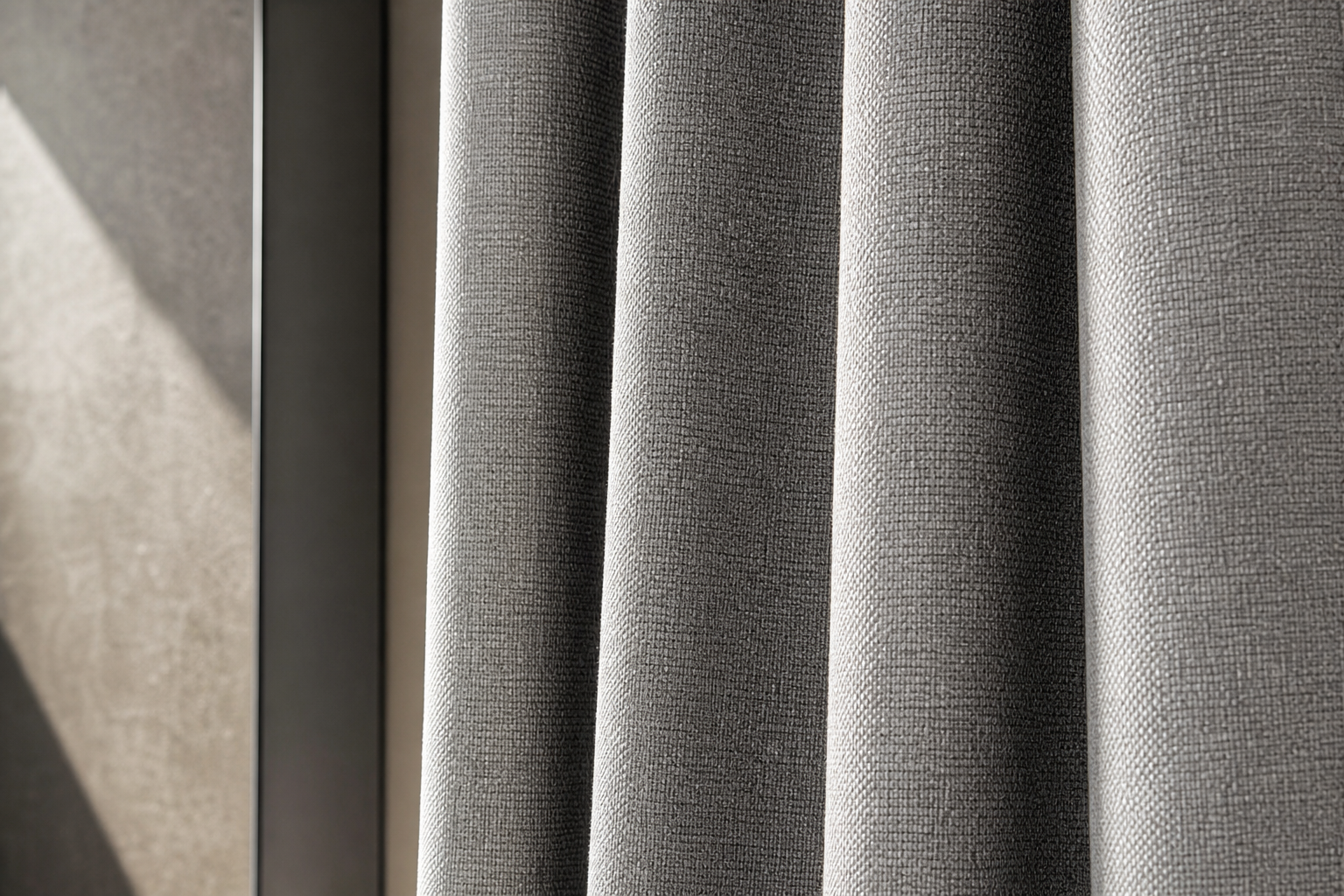 Close-up of substantial woven curtain fabric with visible texture and dense commercial drape