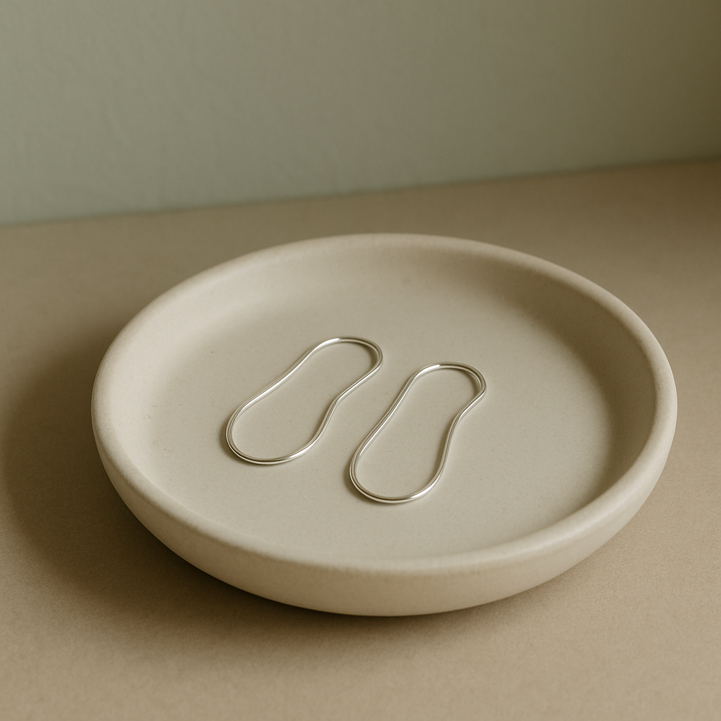 Earrings resting on ceramic dish