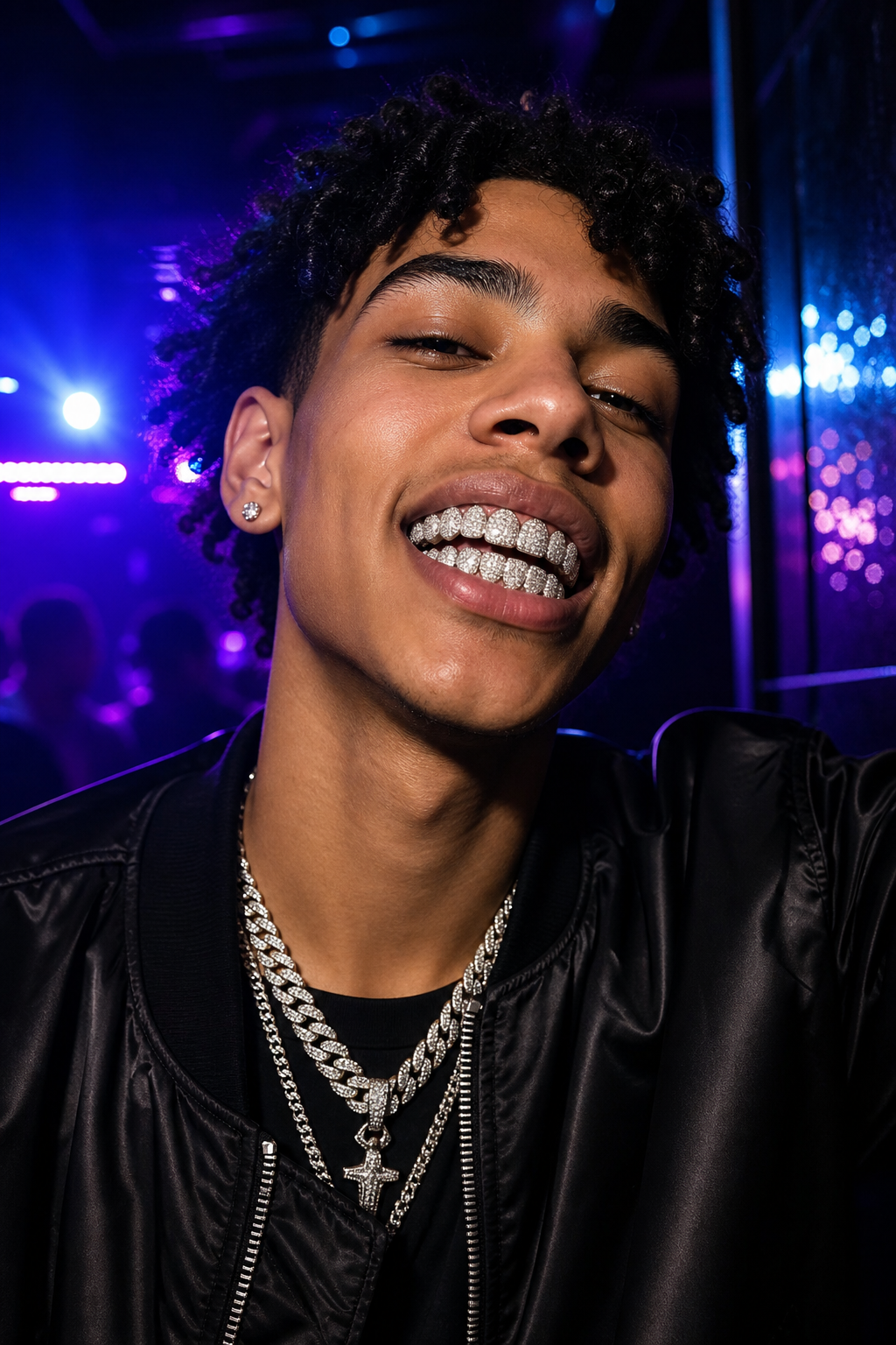 Model in black satin jacket wearing fully iced cubic zirconia grillz under neon nightlife lighting
