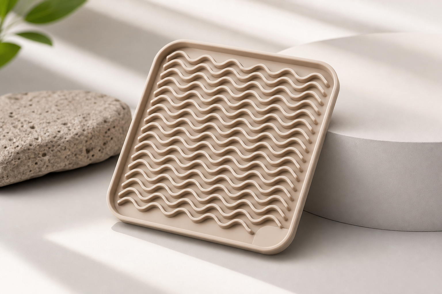 Food-grade silicone lick mat with textured surface and soft neutral tone, styled as a premium pet feeding accessory