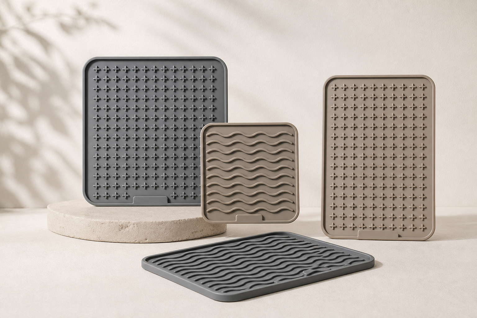Premium square and rectangle silicone lick mats with grid and wave textures photographed on a soft neutral surface.