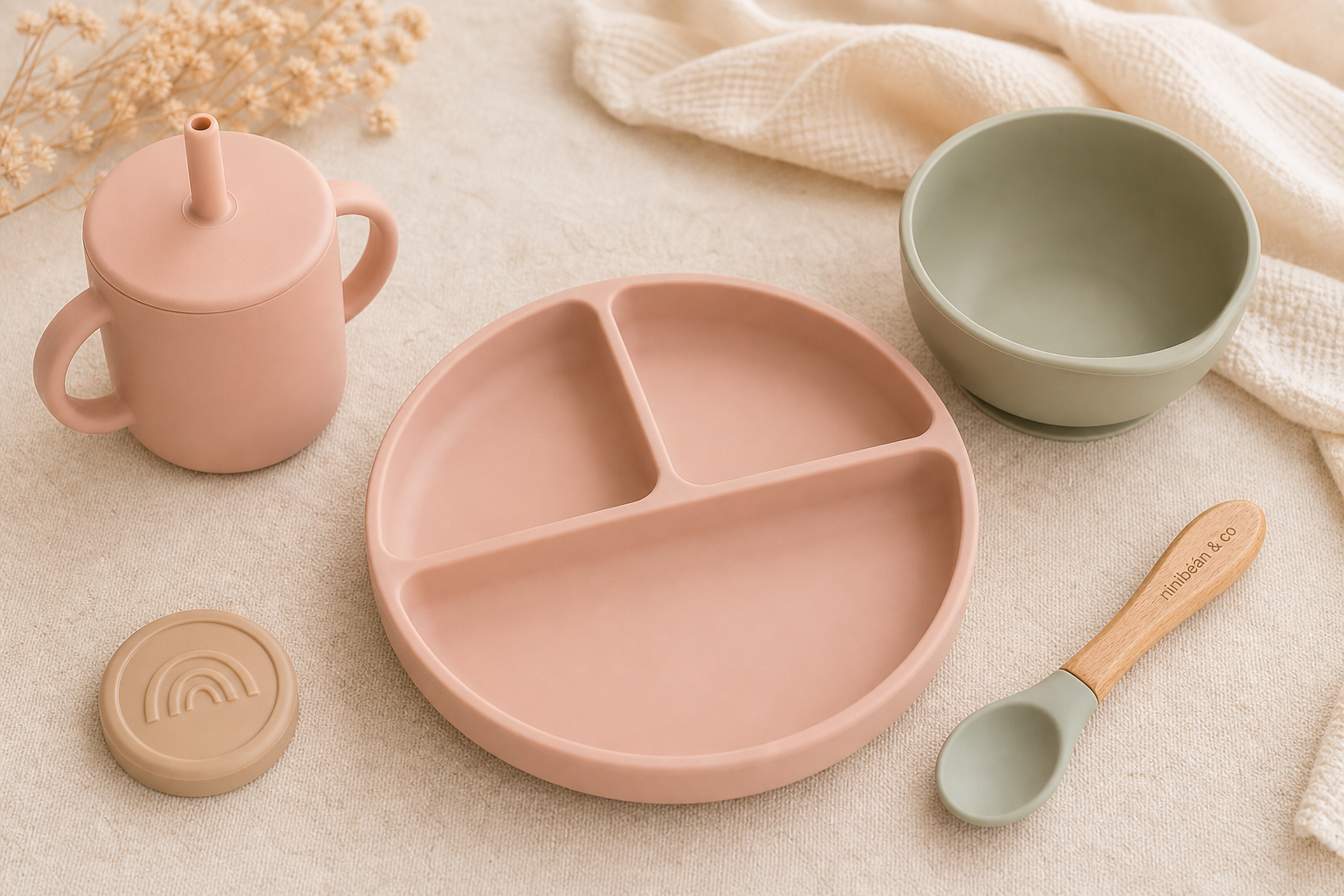 Premium pastel silicone baby feeding set with cup, plate, bowl, and spoon arranged on a soft neutral backdrop