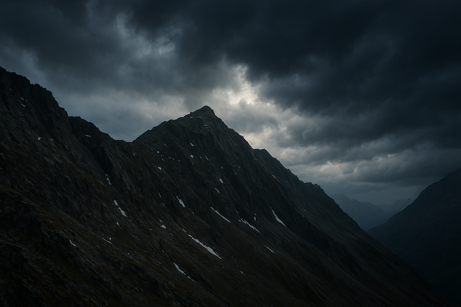 Cold rugged alpine ridgeline beneath shifting storm clouds with dramatic natural light