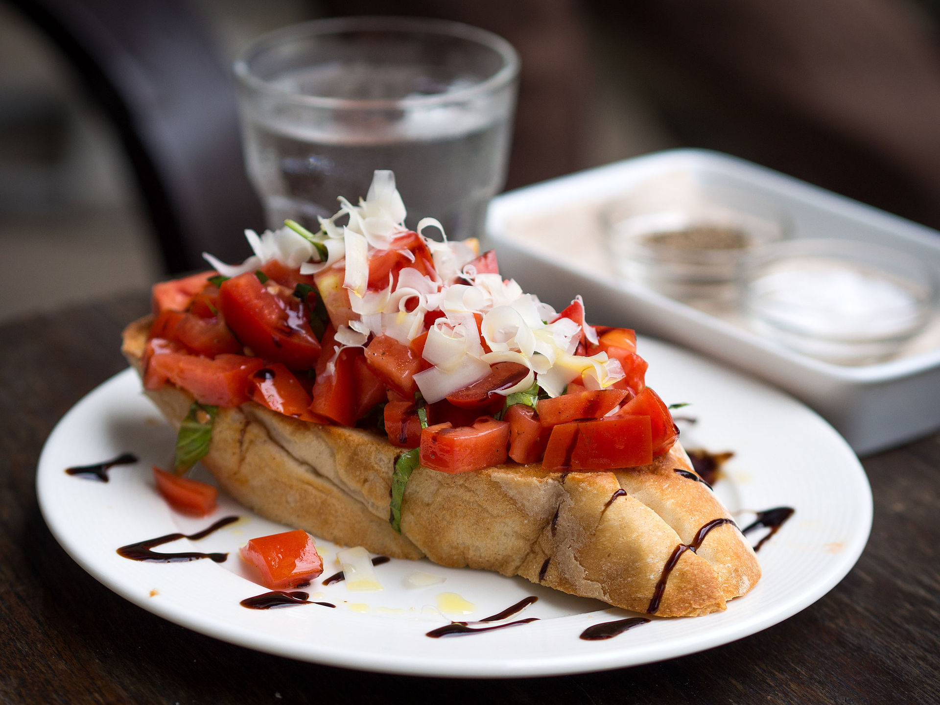 Plate of appetizer toast with tomato