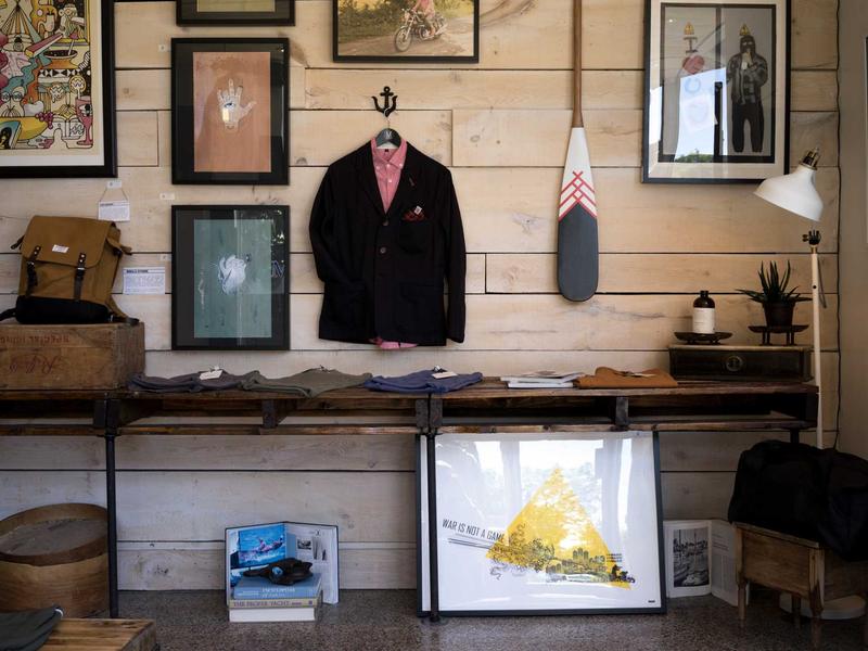 Shop interior with a person standing among shelves and displays