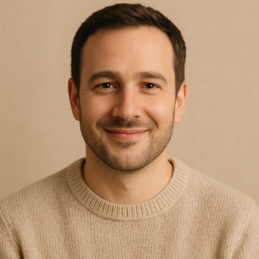 Portrait of Marcus T., a man with short dark hair and warm smile