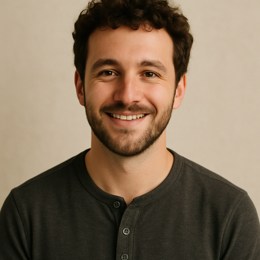 Portrait of Noah J., a young man with curly brown hair and beard